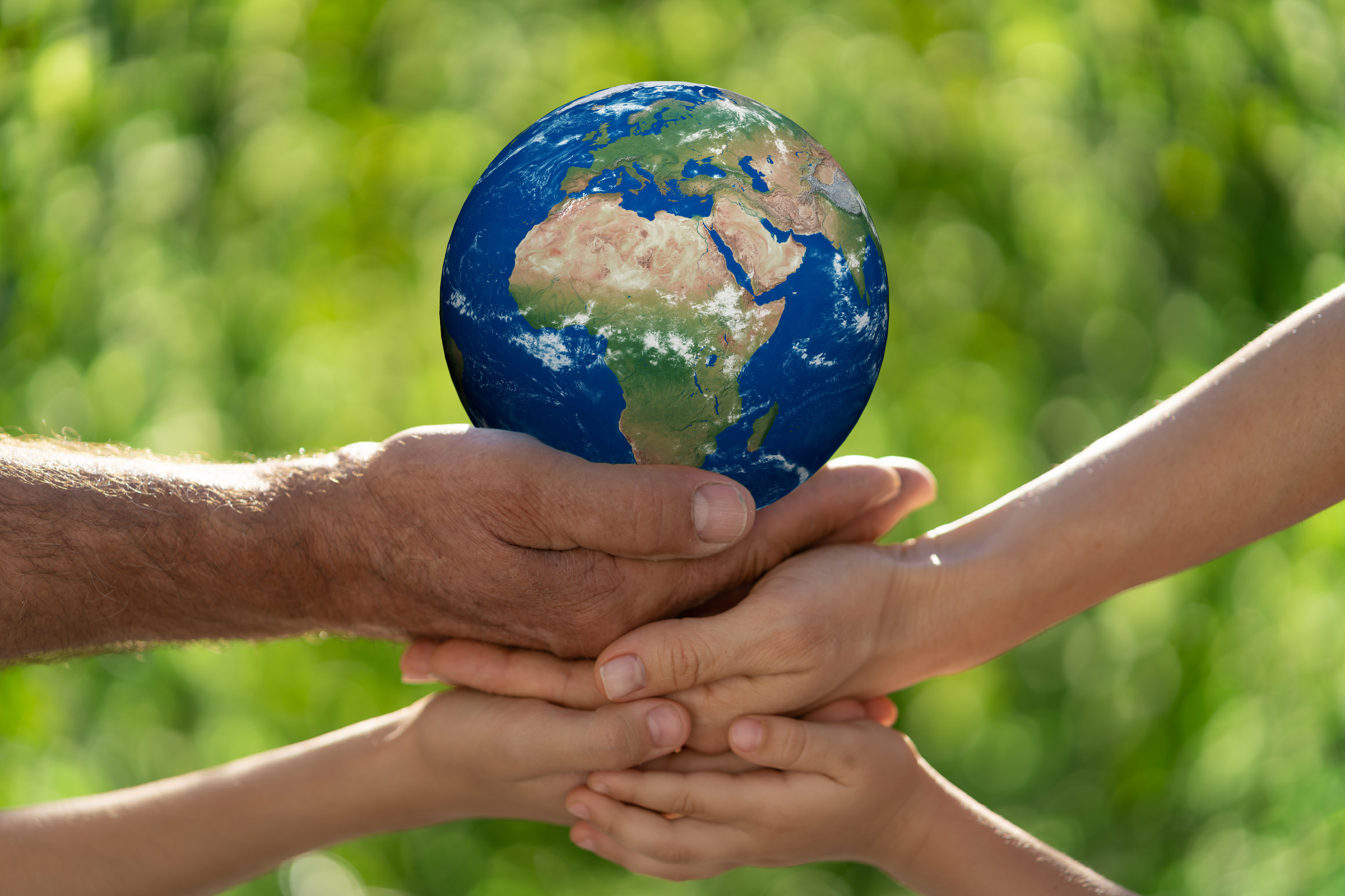 Family Holding Earth Planet in Hands